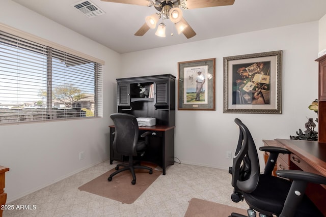 carpeted office featuring ceiling fan