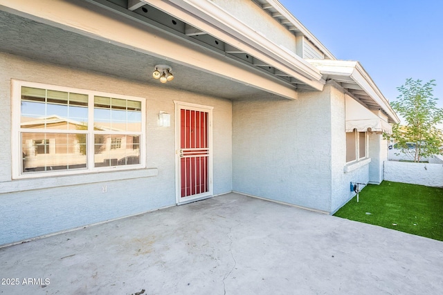 property entrance with a patio area