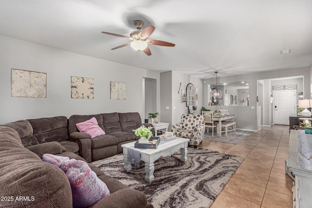 tiled living room with ceiling fan