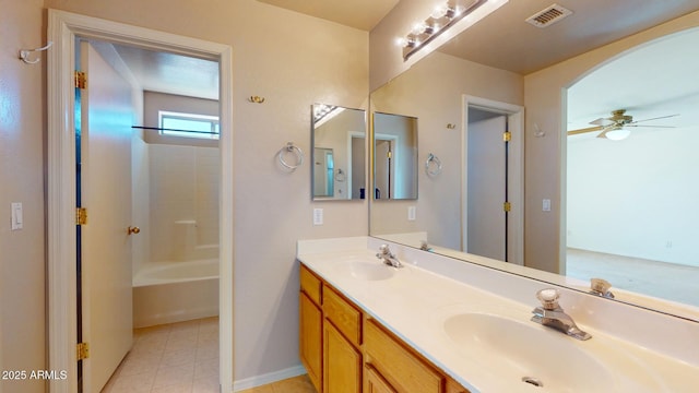 full bath with double vanity, visible vents, ceiling fan, and a sink