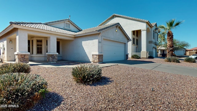 view of front of home with stucco siding, driveway, an attached garage, and a tile roof