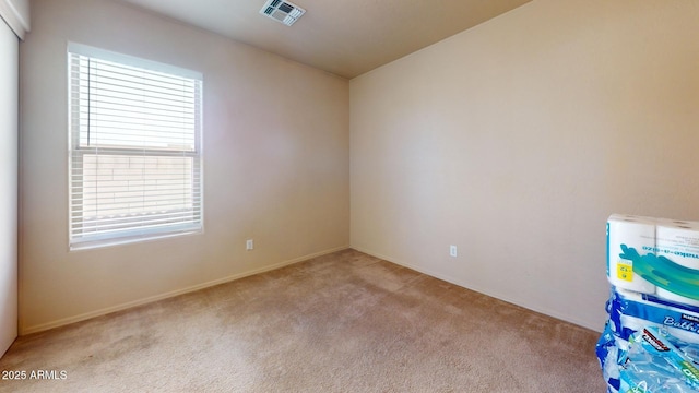 empty room with light colored carpet and visible vents