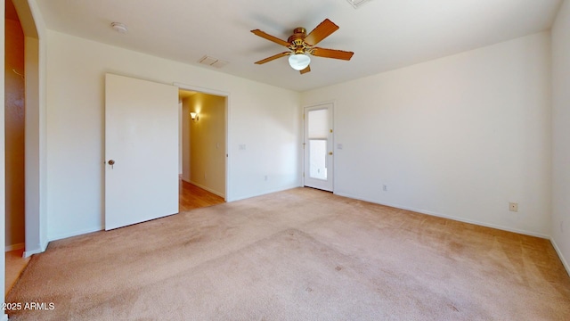 unfurnished bedroom featuring visible vents, carpet flooring, baseboards, and a ceiling fan