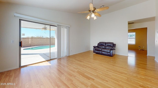 unfurnished room with wood finished floors, visible vents, and ceiling fan