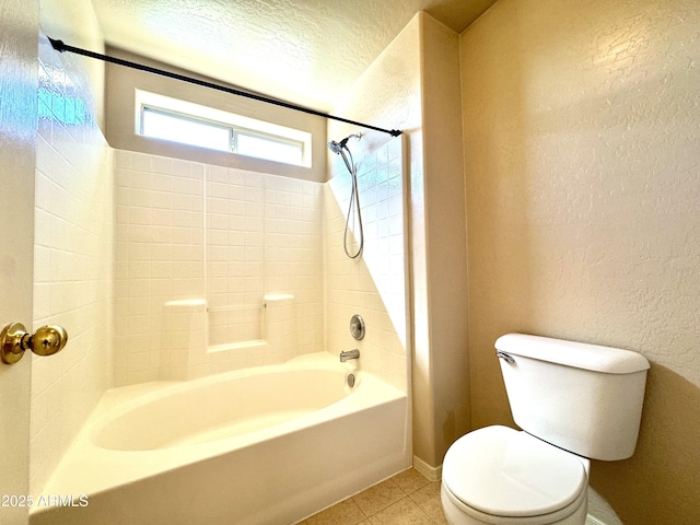 full bathroom with tile patterned flooring, a textured ceiling, toilet, and a textured wall