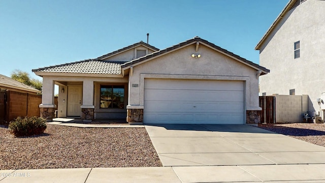 view of front of house featuring stone siding, stucco siding, a garage, and fence