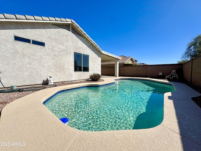 view of swimming pool with a fenced in pool, a patio, and a fenced backyard