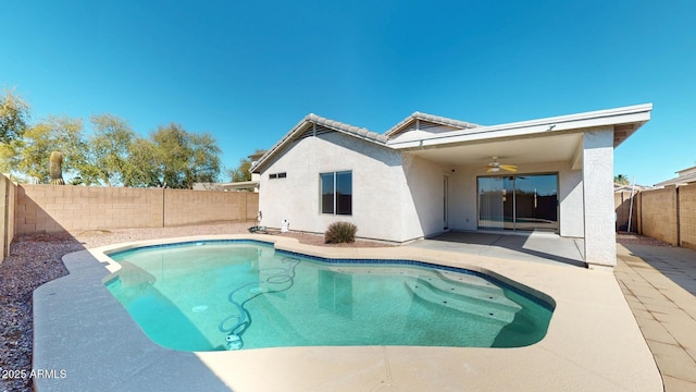 back of house with a ceiling fan, a fenced backyard, stucco siding, a tiled roof, and a patio area