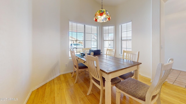 dining room with light wood-style flooring and baseboards