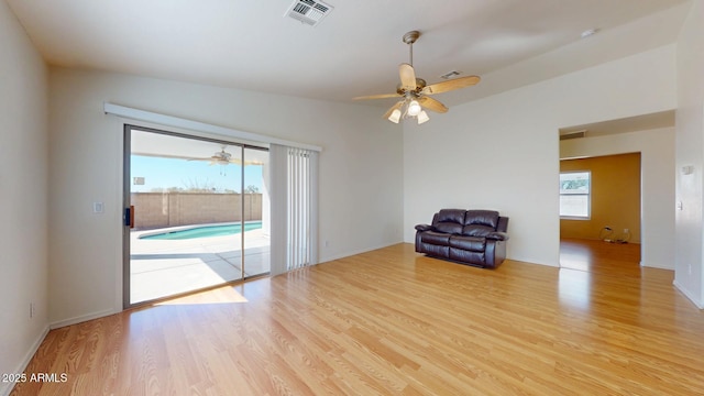 unfurnished room with visible vents, a ceiling fan, and wood finished floors