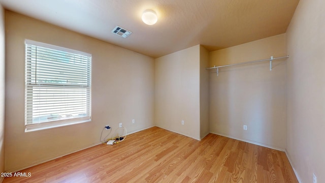 interior space featuring visible vents and light wood-style flooring