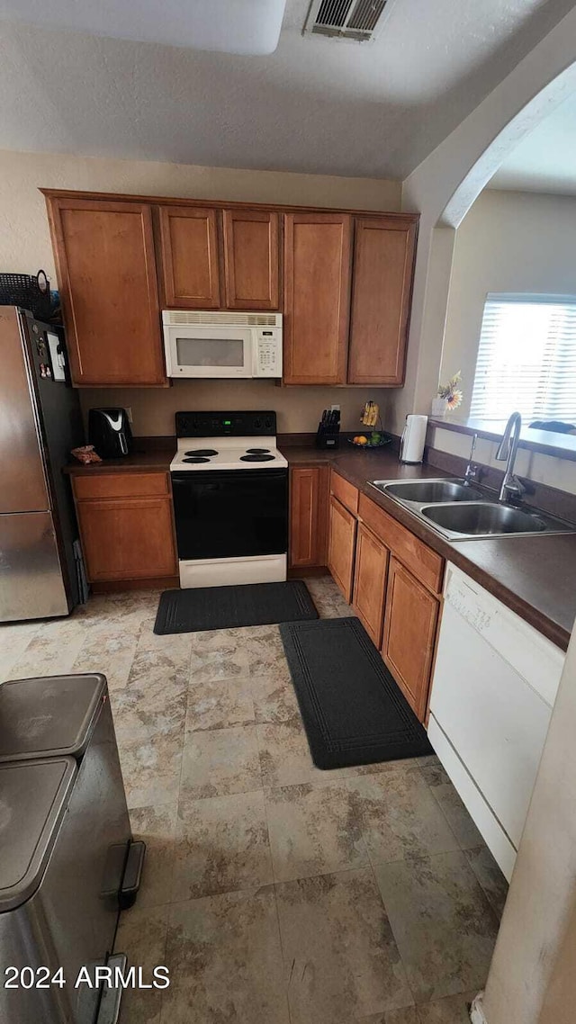 kitchen with sink and white appliances