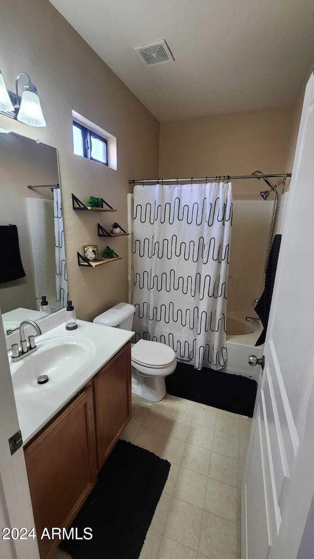 full bathroom with vanity, tile patterned flooring, toilet, and shower / bath combo with shower curtain