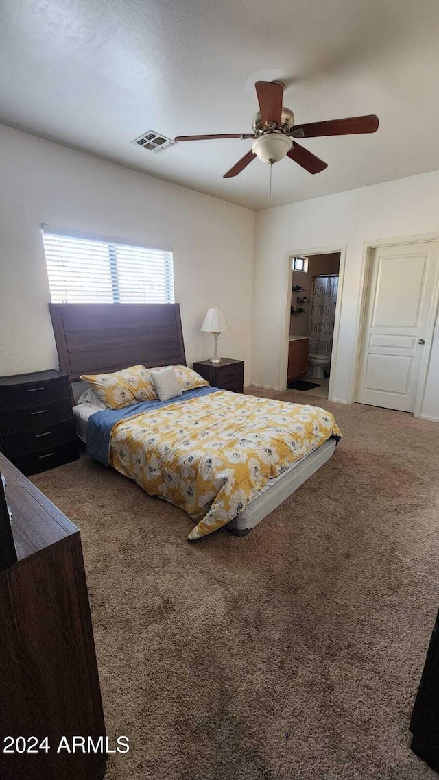 bedroom with ensuite bath, ceiling fan, and carpet flooring