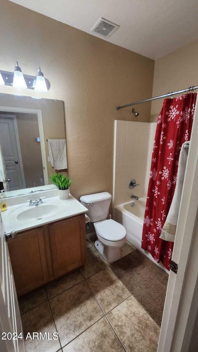 full bathroom featuring shower / bathtub combination with curtain, vanity, tile patterned flooring, and toilet