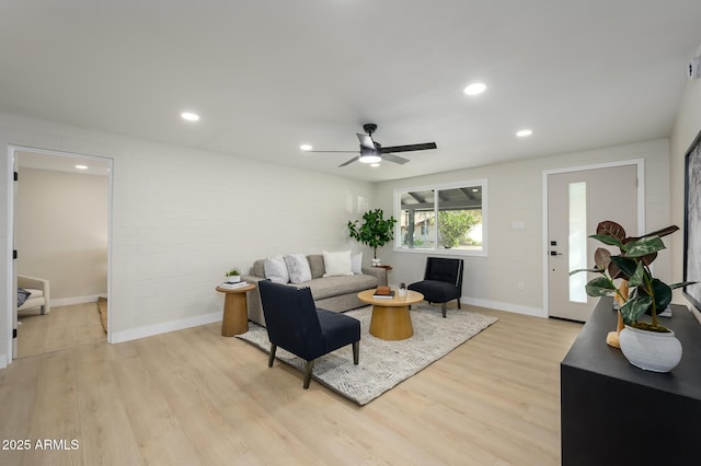 living room featuring ceiling fan and light hardwood / wood-style flooring