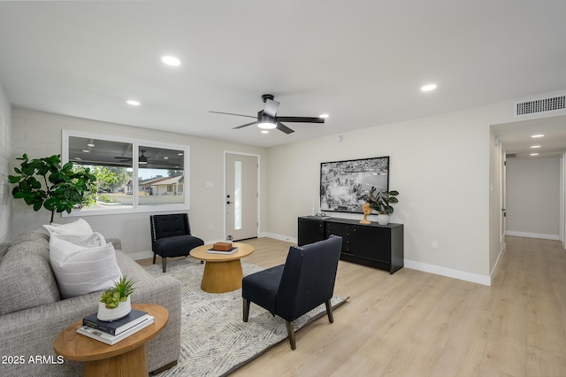 living room with ceiling fan and light hardwood / wood-style floors