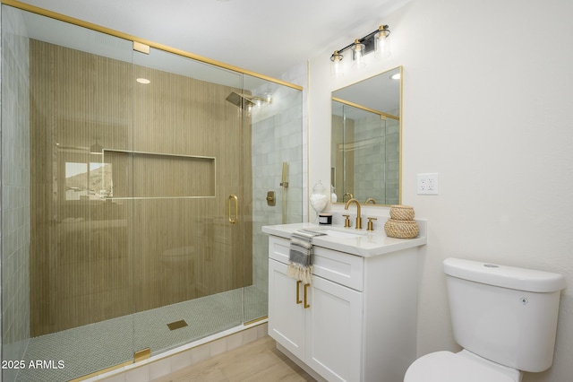 bathroom featuring vanity, toilet, and walk in shower