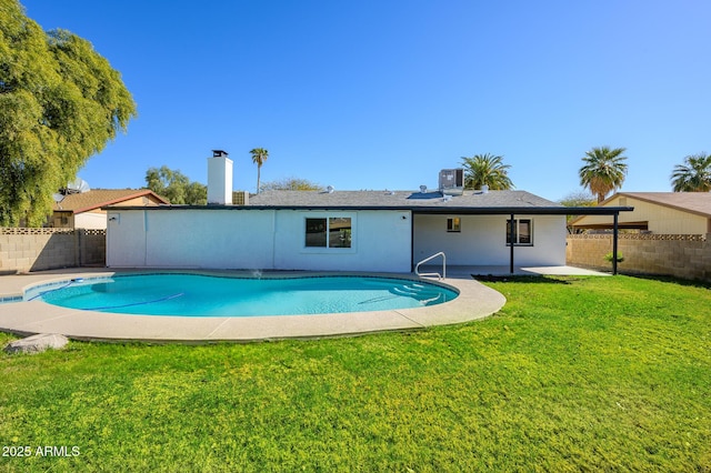 view of swimming pool with a lawn and a patio