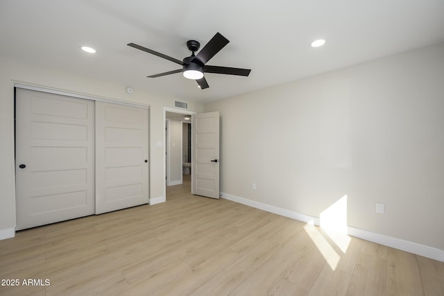 unfurnished bedroom with ceiling fan, light hardwood / wood-style floors, and a closet