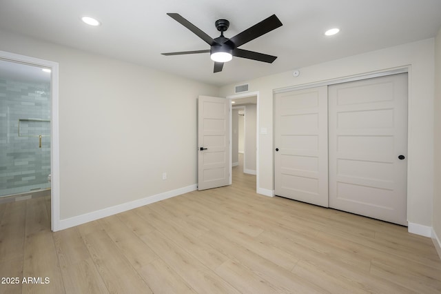 unfurnished bedroom featuring connected bathroom, a closet, ceiling fan, and light wood-type flooring