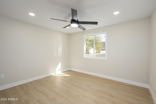 spare room with light hardwood / wood-style floors and ceiling fan