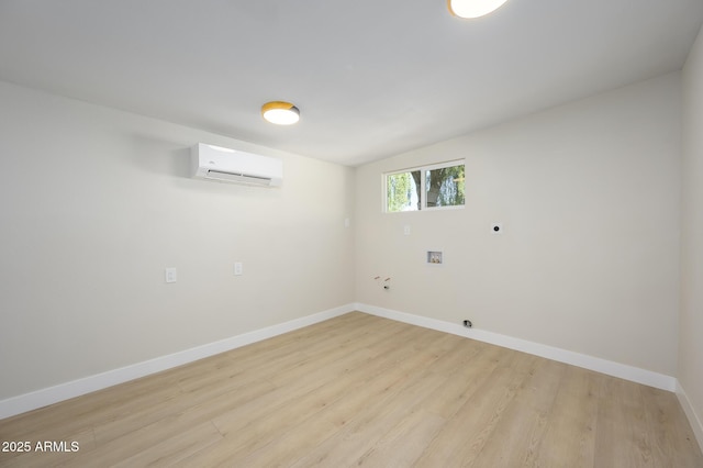 interior space with a wall unit AC and light hardwood / wood-style flooring