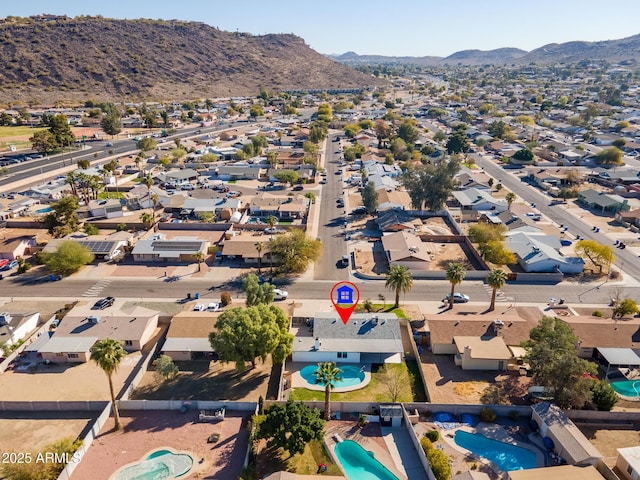 birds eye view of property with a mountain view