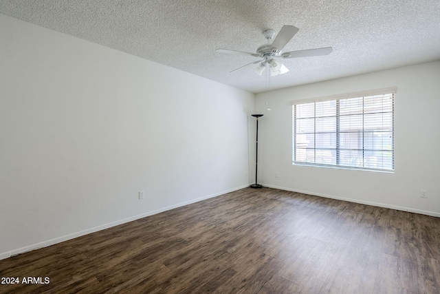 empty room with a textured ceiling, dark hardwood / wood-style flooring, and ceiling fan