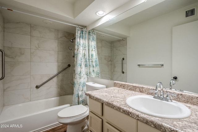 full bathroom featuring hardwood / wood-style flooring, shower / bath combo, toilet, and vanity