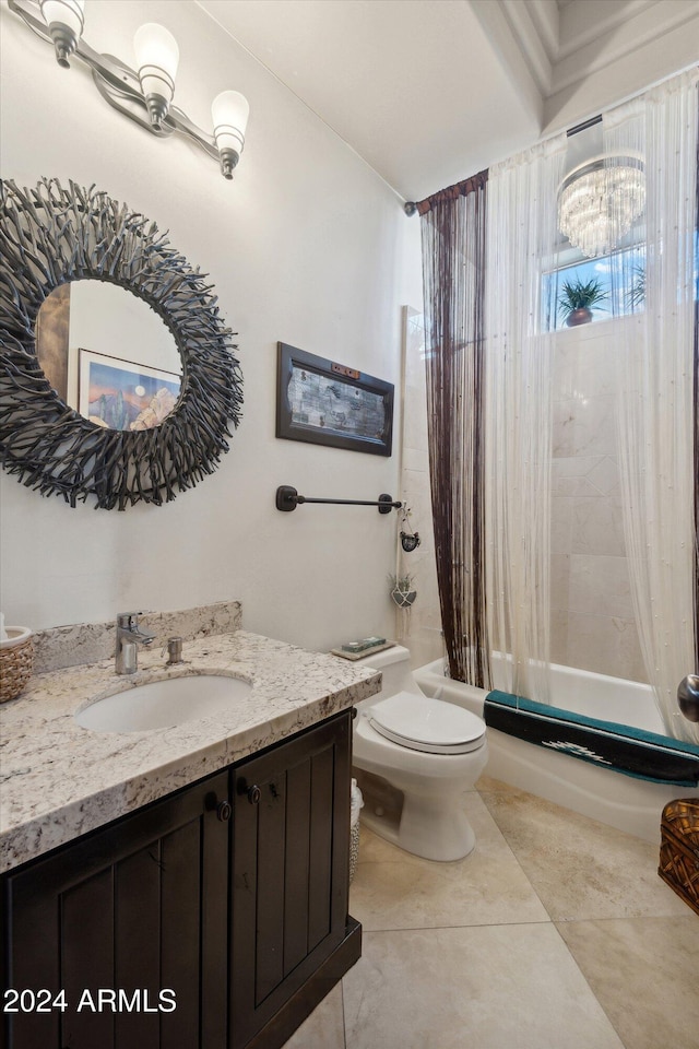 full bathroom with a notable chandelier, tile patterned floors, toilet, shower / tub combo with curtain, and vanity