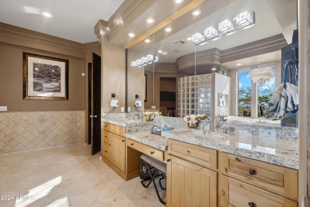 bathroom featuring vanity, an inviting chandelier, and tile walls