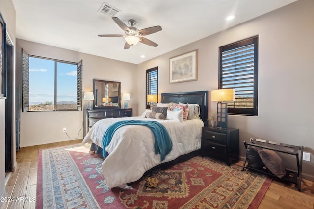 bedroom with hardwood / wood-style floors and ceiling fan