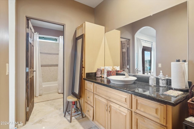 bathroom featuring washtub / shower combination and vanity