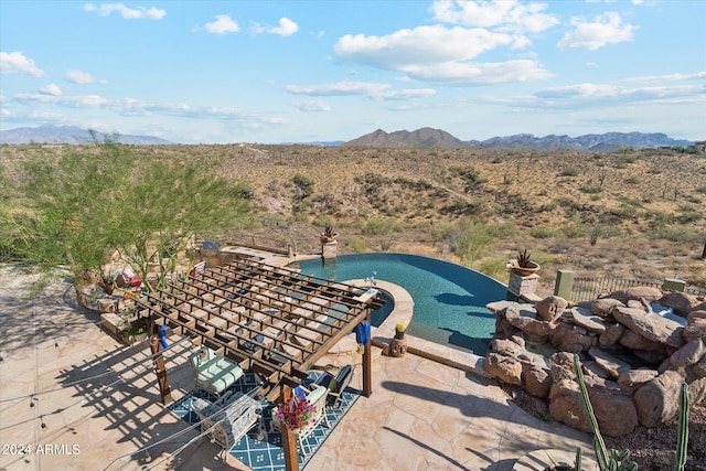 view of pool with a mountain view and a patio