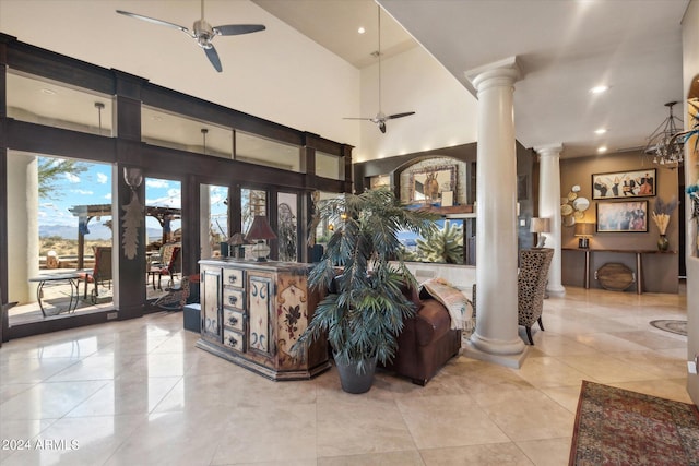 living room featuring ceiling fan, ornate columns, and light tile patterned floors