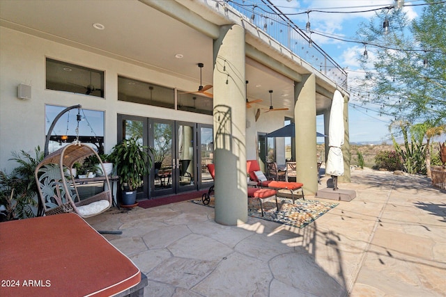 view of patio / terrace featuring ceiling fan and french doors