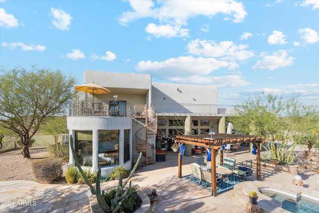 rear view of house featuring a pergola, a balcony, a swimming pool, and a patio