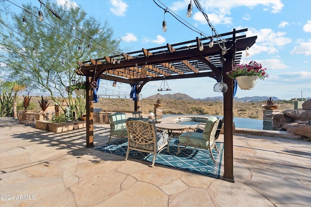 view of patio with a mountain view and a pergola