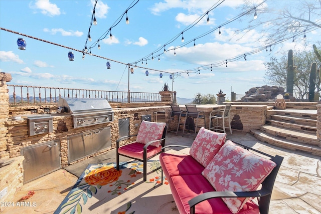 view of patio / terrace featuring grilling area, an outdoor bar, and an outdoor kitchen