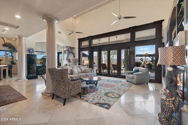 living room with ceiling fan, high vaulted ceiling, and light tile patterned flooring