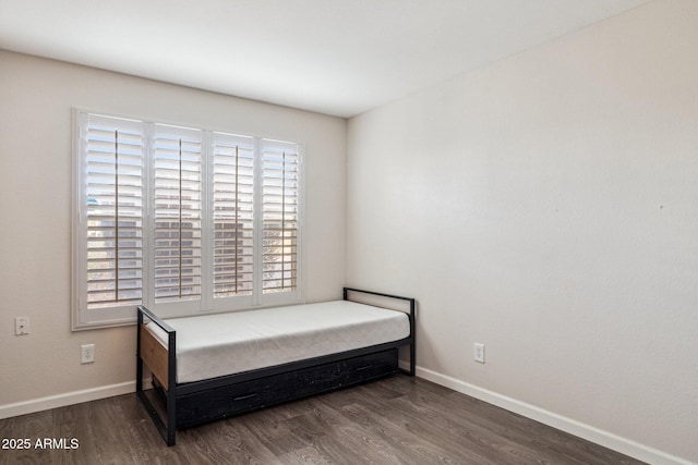 bedroom featuring wood finished floors and baseboards