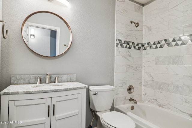 bathroom with toilet,  shower combination, a textured wall, and vanity