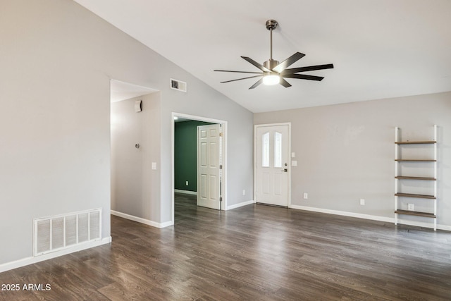 empty room with dark wood-type flooring, visible vents, vaulted ceiling, and ceiling fan