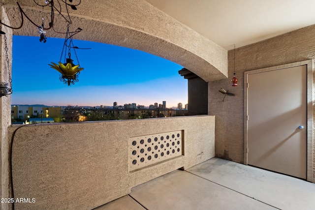 patio terrace at dusk with a balcony