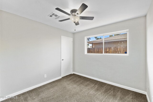 6714 N 26th Dr, Phoenix, AZ 85017 - empty room with dark carpet, baseboards, a ceiling fan, and visible vents