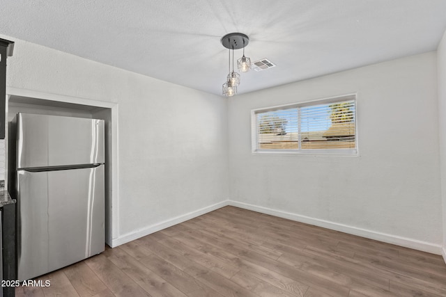 6714 N 26th Dr, Phoenix, AZ 85017 - unfurnished room featuring visible vents, baseboards, and wood finished floors