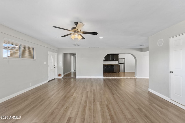 6714 N 26th Dr, Phoenix, AZ 85017 - unfurnished living room with light wood-style floors, ceiling fan, arched walkways, recessed lighting, and baseboards