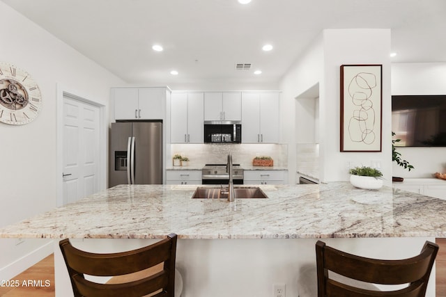 11500 E Cochise Dr Unit 1015, Scottsdale, AZ 85259 - kitchen with a sink, a kitchen breakfast bar, stainless steel appliances, and visible vents