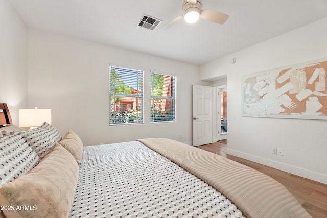 11500 E Cochise Dr Unit 1015, Scottsdale, AZ 85259 - bedroom featuring baseboards, ceiling fan, wood finished floors, and visible vents